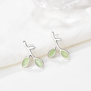 Macro view of S925 sterling silver leaf stud earrings with light green cat eye stone