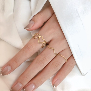 Minimalist gold hollow heart and wavy stacking ring set for women on fingers
