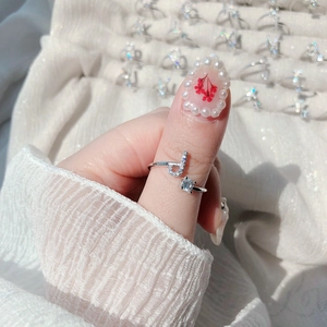Detail of adjustable silver ring featuring a crystal letter J and a round zircon stone