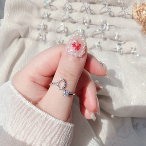 Detail of adjustable silver ring with zircon inlay and offset square diamond design