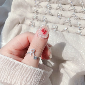Close-up of silver adjustable ring with crystal R letter and sparkling zircon stone