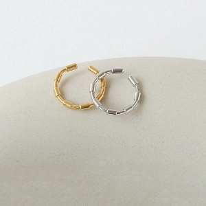 Minimalist gold and silver bamboo-style open rings with polished metallic finish
