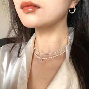 Double-layer pearl necklace with a rectangular pendant and sleek silver hoop earrings