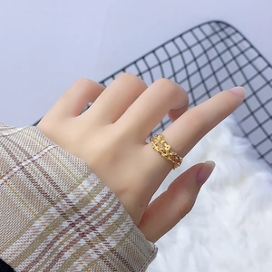 Minimalist 18K gold S925 silver ring with irregular lava texture worn on the index finger
