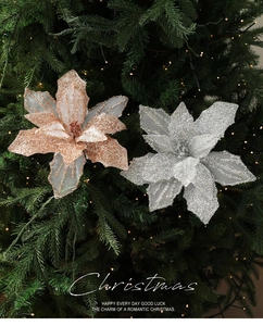 Close-up of sparkling rose gold and silver mesh Christmas flowers on tree
