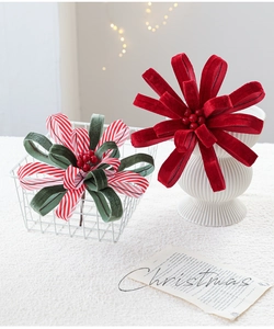 Macro detail of red velvet and striped ribbon Christmas picks with faux red berries