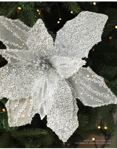 Detail of silver glitter mesh flower ornament with sequins on a decorated Christmas tree