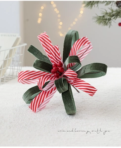 Detail of Christmas ribbon floral pick with red berries and striped velvet textures