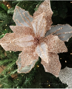 Macro detail of champagne gold glitter poinsettia flower with translucent mesh petals