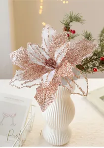 Detailed close-up of rose gold glitter mesh Christmas poinsettia flower in a ceramic vase