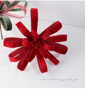 Close-up of red velvet Christmas flower with glossy berries and warm loving quote