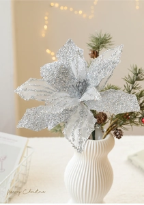 Silver artificial Christmas flower with glitter texture in a white vase decoration