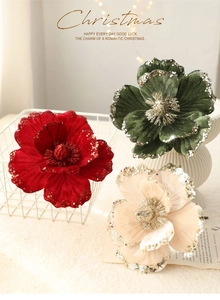 Close-up of velvet Christmas flower with gold sequins and glitter in festive setting