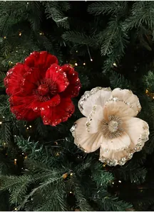 Detail of red velvet Christmas magnolia flower with glitter edges on tree branch