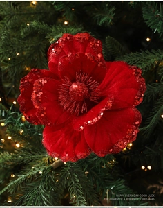 Macro detail of red flocked Magnolia Christmas flower with sequins and glitter centers