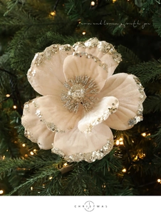 Close-up of velvet Christmas magnolia flower with gold sequins and stamen on a tree