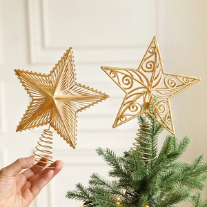 Golden hollowed-out Christmas tree star topper with elegant filigree and radial design