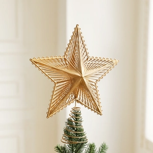 Golden hollow star tree topper with radiant geometric design and spring base