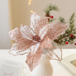 Sparkling champagne mesh Christmas flower with gold glitter edges in a ceramic vase
