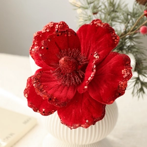 Red velvet Christmas flower with glitter edges in a white vase with pine needles