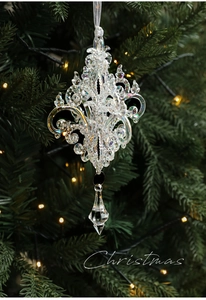 Close-up of iridescent acrylic Christmas tree ornament with elegant crystal chandelier design
