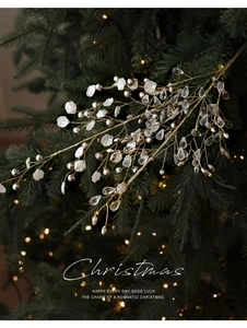 Detail of Christmas tree pick with white shell petals, golden beads and crystal drops