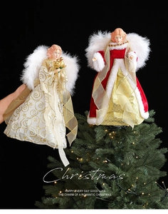 Detail of Christmas tree topper angel dolls with white feather wings and velvet dresses