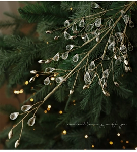 Detail of Christmas tree branch decoration with crystal drops and golden finish