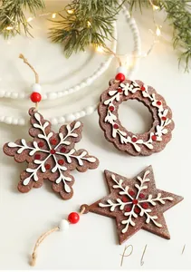 Detail of wooden Christmas gingerbread ornaments with snowflake patterns and red glitter