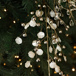 Golden Christmas tree branch with crystal water drops and white shell leaf decorations