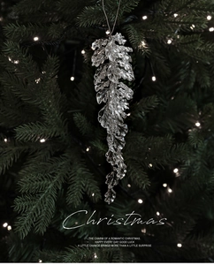 Detailed view of clear acrylic pinecone ornament with ice crystal texture on Christmas tree