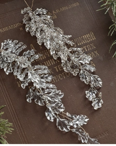 Macro view of champagne pink acrylic leaf ornaments with glitter on a vintage book
