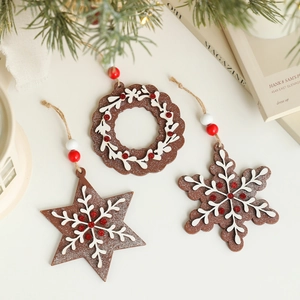 Three-piece wooden Christmas pendants with snowflake and star designs on warm background