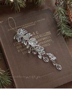 Detail of acrylic champagne pink leaf pendant on vintage book for Christmas tree decor
