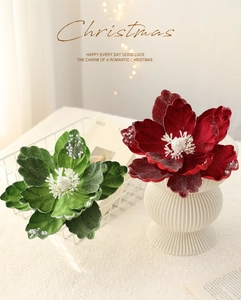 Detailed view of red and green velvet Christmas flowers with pearls and frost effect