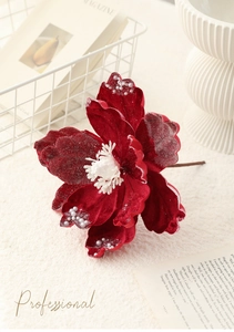 Macro detail of dark red velvet magnolia flower with pearl beads and white stamen decor