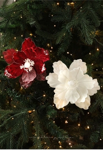 Close-up of luxury flocked Christmas flowers with glitter on a decorated pine tree