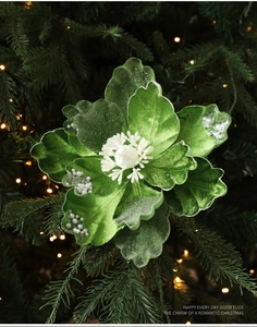 Detail of green velvet Christmas magnolia flower with pearls and snowflake stamen