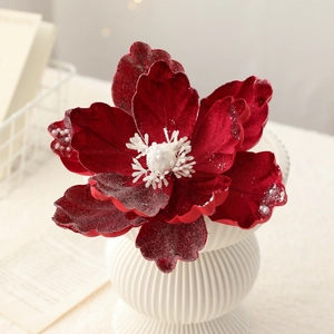 Deep red flocked magnolia Christmas flower with pearl center in a white ceramic vase