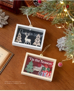 Detailed view of layered 3D wooden Christmas ornaments with reindeer and tree motifs