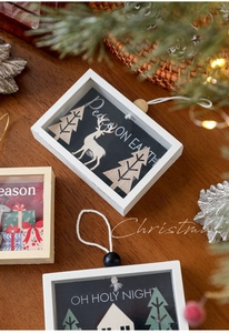 3D laser-cut wooden Christmas ornaments with reindeer scenes and festive peace on earth text