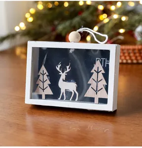 Close-up of wooden Christmas frame with Peace On Earth text and 3D deer silhouette