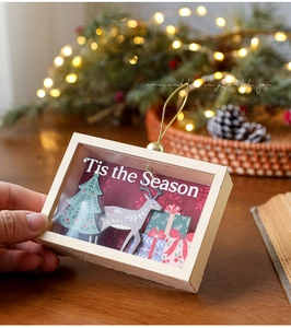 Detailed view of wooden Christmas shadow box with 3D reindeer and holiday tree