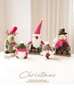 Detail of five felt Christmas figurines including reindeer and gnomes on wood bases