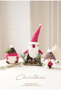 Detail of Christmas gnomes with pink hats, white beards, and natural pine cone bodies
