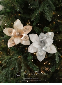 Close-up of champagne gold and silver fabric Christmas flowers with glitter on tree