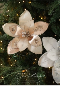 Close-up of glittery fabric Christmas flowers with sequins on a decorated Xmas tree