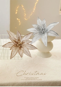 Detail of glittered 20cm artificial poinsettia flowers in gold and silver for Christmas