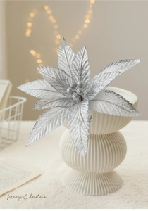 Sparkling silver glitter poinsettia flower in a ceramic vase for holiday decoration
