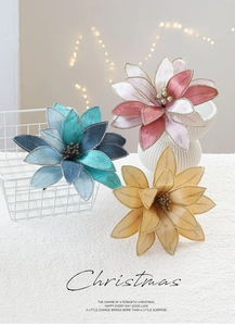 Detail of luxury fabric poinsettia with gold glitter edges in festive basket